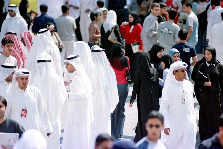 Male and female students gather during their break in the grounds of Kuwait University 14 October 2001. Lecture halls at the university allow for co-education despite a law passed by Kuwait's parliament five-years-ago banning the practice. Some Kuwaiti legislators threatened to grill the Minister of Education and Minister of Higher Education Dr. Musaed Al-Haroun for not implementing the law. Haroun, however, recently submitted a report to the Cabinet explaining the difficulties, mainly financial and shortage of space, to implement such segregation at the university. AFP PHOTO/Yasser AL-ZAYYAT (Photo by YASSER AL-ZAYYAT / AFP)
