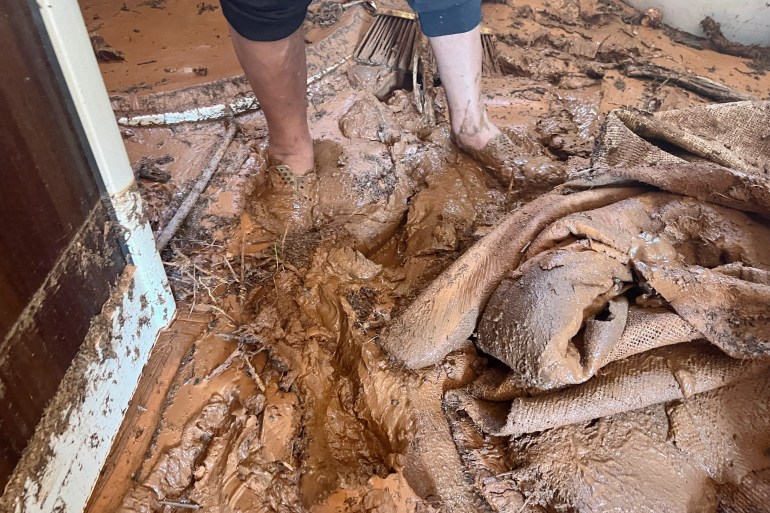 A view shows the legs of a Libyan resident, Saad Rajab al-Hassi, stuck in the mud at his house, in the aftermath of the floods in Susah, Libya September 15, 2023. REUTERS/Ayman Al-Sahili