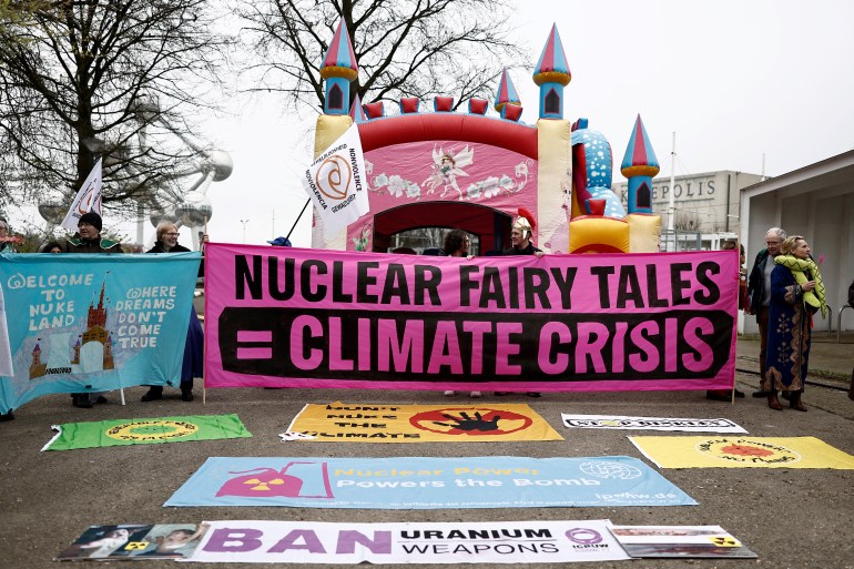 Protesters take part in an anti-nuclear demonstration near the entrance of the Brussels Expo convention centre, on the sidelines of the International Atomic Energy Agency (IAEA) Nuclear Energy Summit, in Brussels on March 21, 2024. (Photo by Sameer Al-Doumy / AFP)