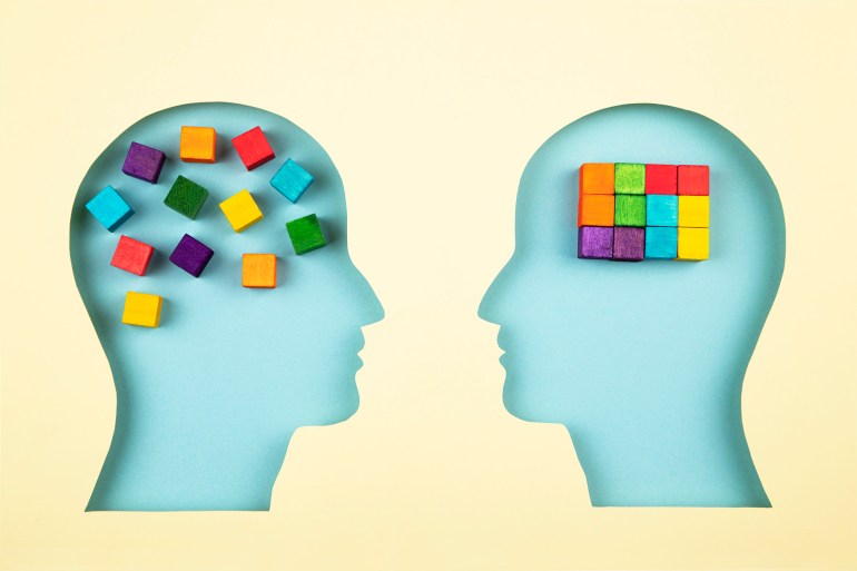 Human heads in paper cut style with multicolored cubes for a concept of creative thinking