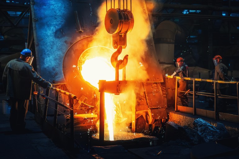 Process of casting in foundry, liquid molten metal pouring in ladle. Heavy metallurgy industry
